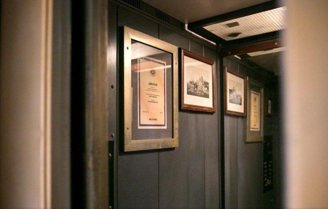 Кабина лифта украшена дипломами и любимыми фотографиями автора необыкновенной идеи